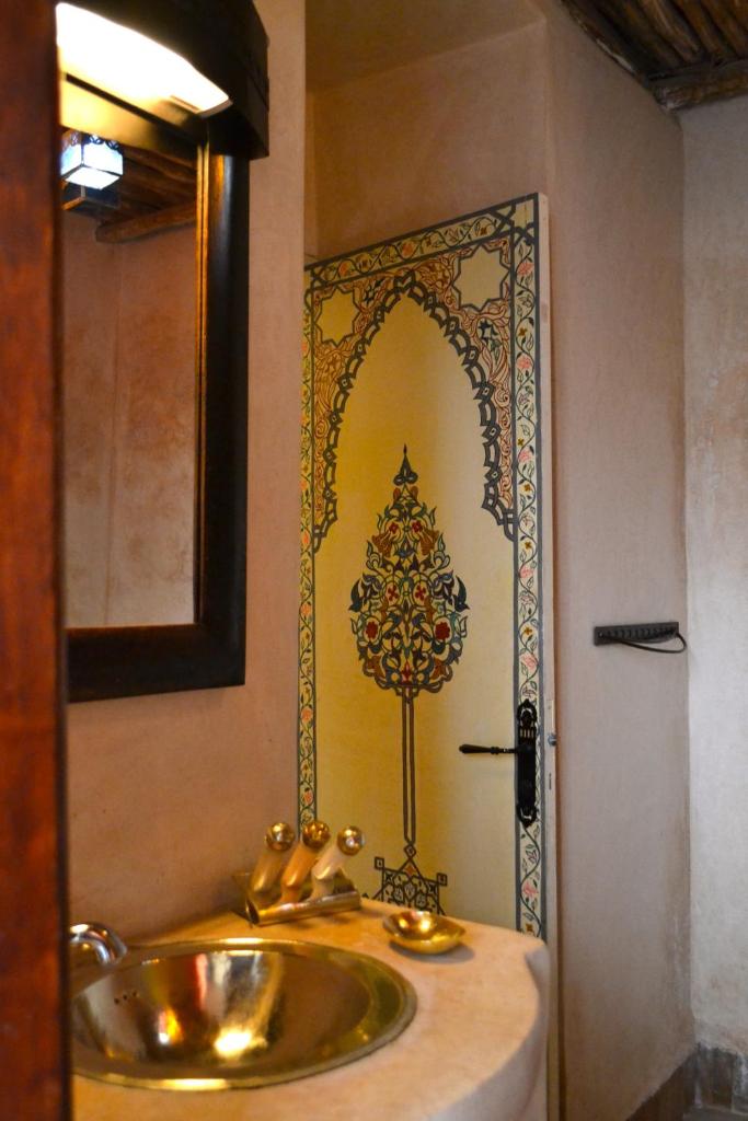 une salle de bain avec un lavabo et un miroir dans l'établissement Riad Amira, à Marrakech