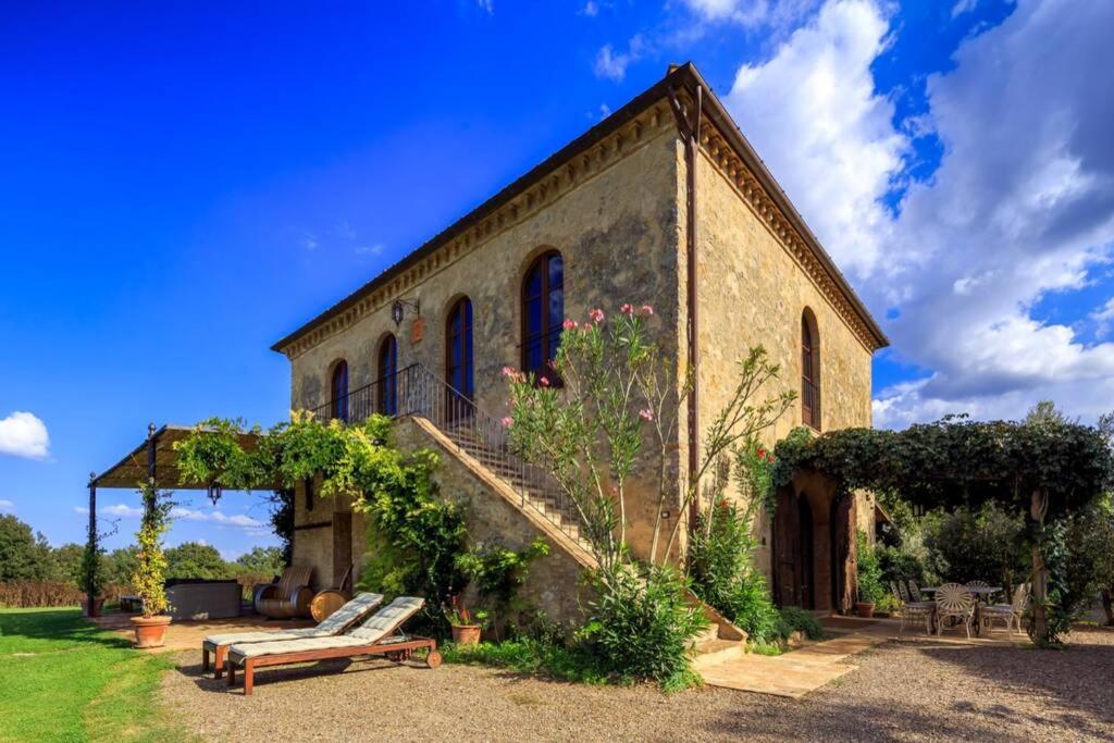 un vieux bâtiment en briques avec un escalier et un banc dans l'établissement Il Fienile di Montesoli, à Villa Montesoli