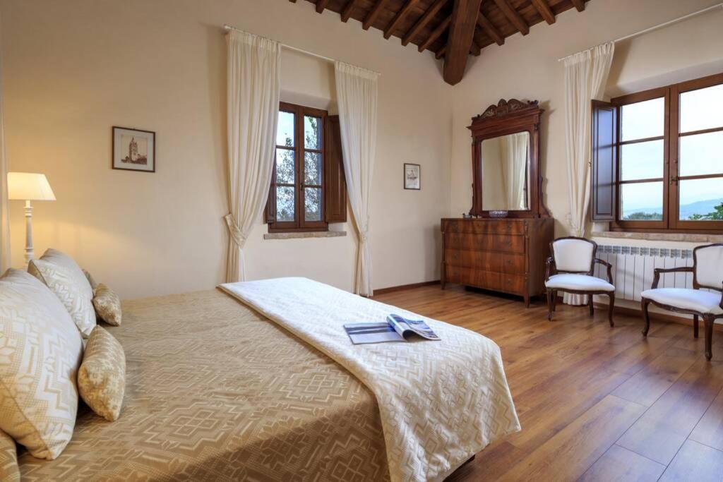 une chambre avec un lit, une table et des chaises dans l'établissement Il Fienile di Montesoli, à Villa Montesoli