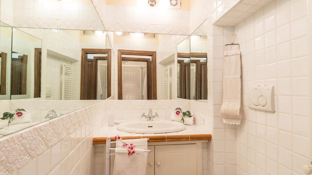 une salle de bain avec un lavabo et un grand miroir dans l'établissement MULINO DELLA QUERCIA 2&1, Emma Villas, à Cetona 16 autres photos