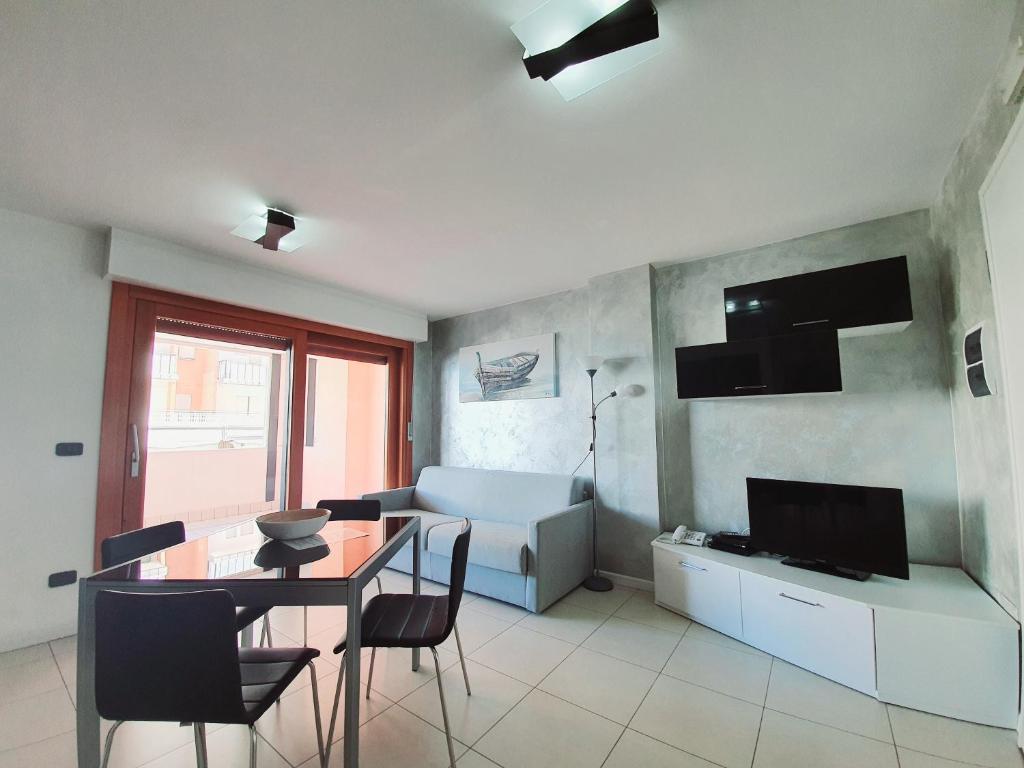 un salon avec une table à manger et une télévision dans l'établissement Aparthotel Capitol, à Grado 67 autres photos