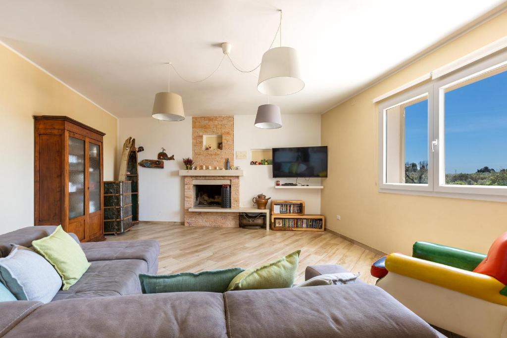 un salon avec deux canapés et une cheminée dans l'établissement Villa Il Neto by BarbarHouse, à Casarano