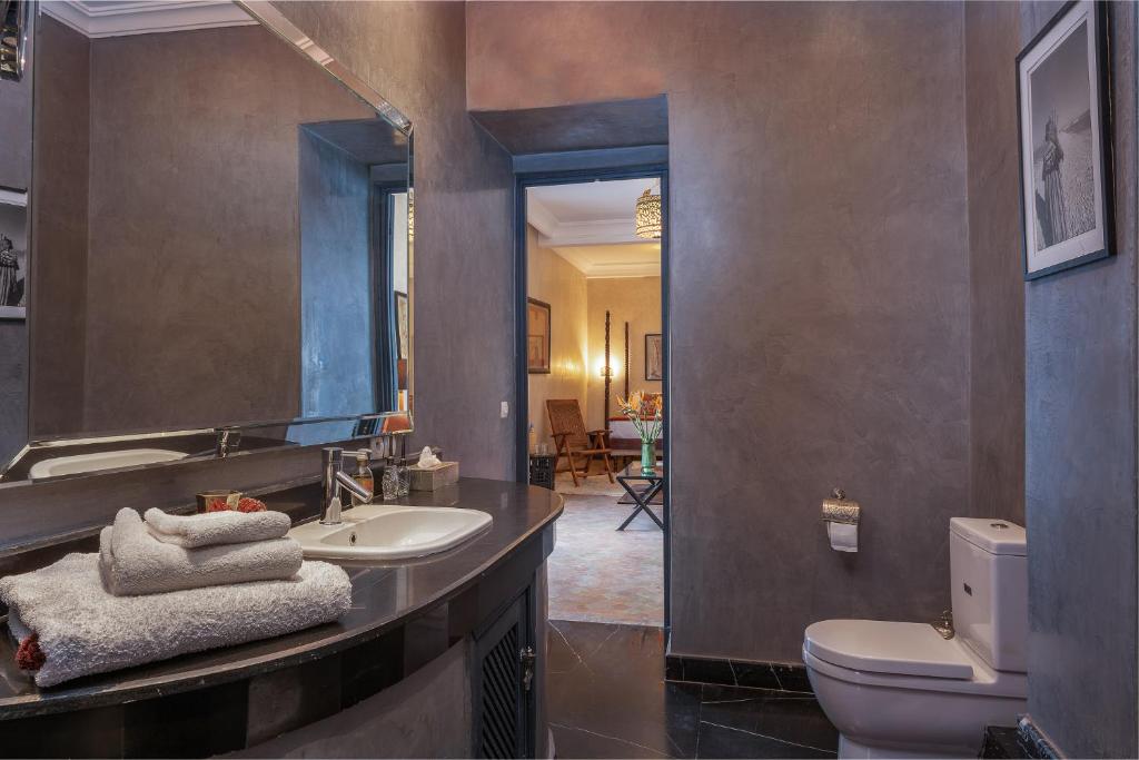 une salle de bain avec un lavabo, des toilettes et un miroir dans l'établissement Riad D'ari, à Marrakech 28 autres photos