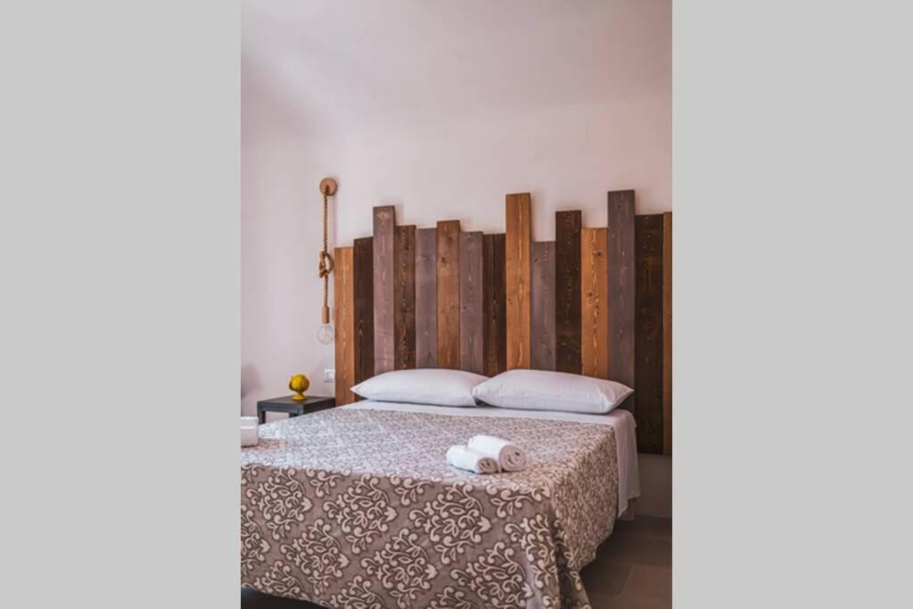 un lit avec un animal fourré blanc au dessus de celui-ci dans l'établissement Tenuta Trullo Acquaro Ostuni, à Ostuni