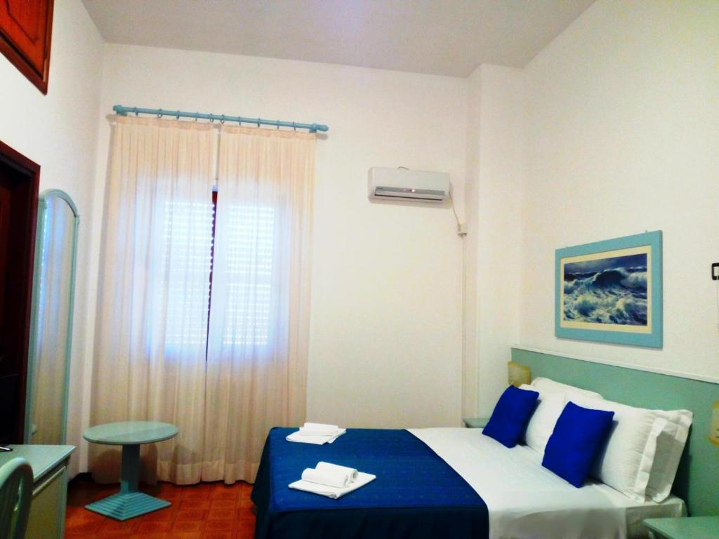 une chambre avec un lit bleu et blanc et une fenêtre dans l'établissement Hotel Mercede 2, à San Felice Circeo 34 autres photos