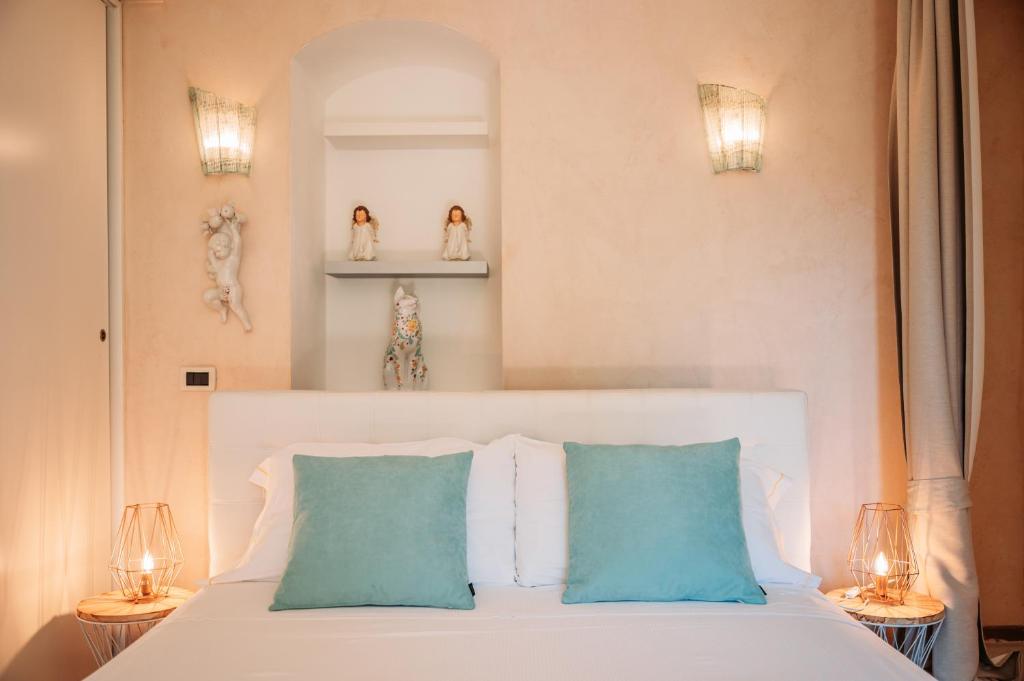 une chambre avec un lit blanc avec deux oreillers bleus dans l'établissement Private Villa at Villa al Duomo, à Taormine 39 autres photos