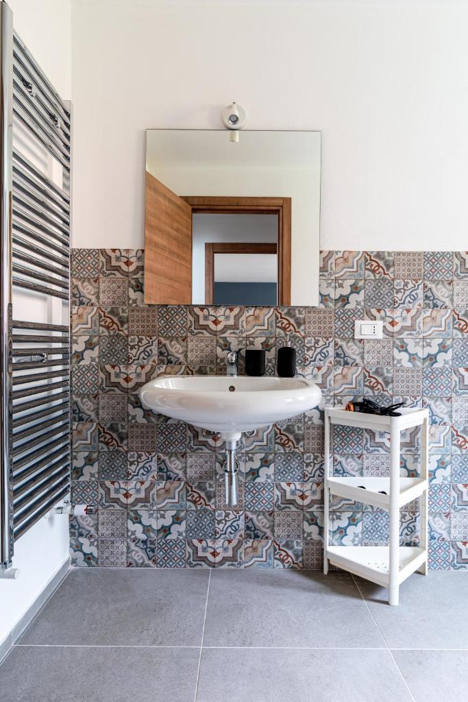 une salle de bain avec un lavabo et un miroir dans l'établissement Elegante Villa con Piscina privata a Scopello, à Castellammare del Golfo