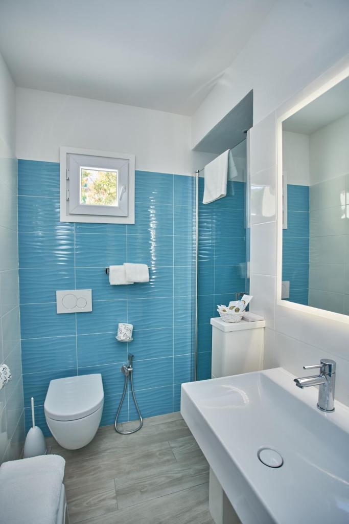 une salle de bain bleue avec des toilettes et un lavabo dans l'établissement Hotel La Stella, à Seccheto