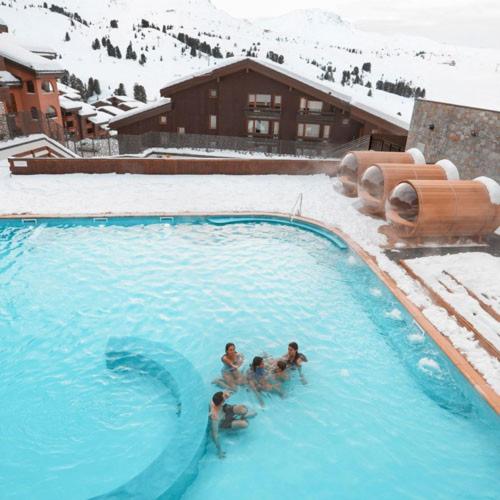 un groupe de personnes dans une piscine dans la neige dans l'établissement DUPLEX 6P A BELLE-PLAGNE (2050 m), SKIS AUX PIEDS, EN PLEIN CŒURS DE LA STATION RESIDENCE LE BERYL., à Belle Plagne 13 autres photos