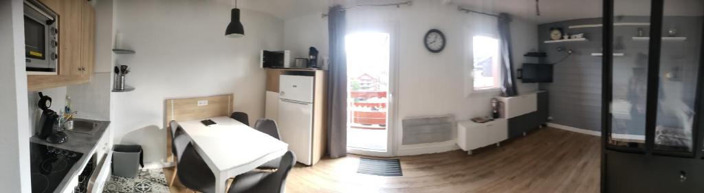 Cette chambre dispose d'un bureau et d'une horloge murale. dans l'établissement Risoul Appartement Rénové Piscine Balcons de Sirius, à Risoul