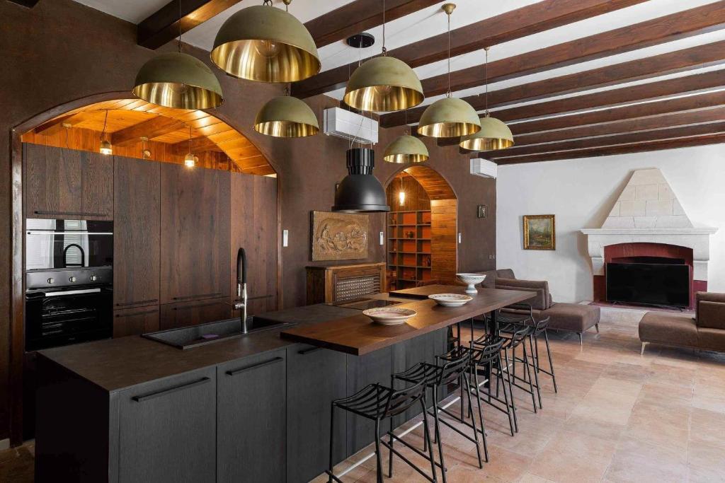 une cuisine avec un grand îlot et des tabourets de bar dans l'établissement Trullo Ad Caelum, à Fasano