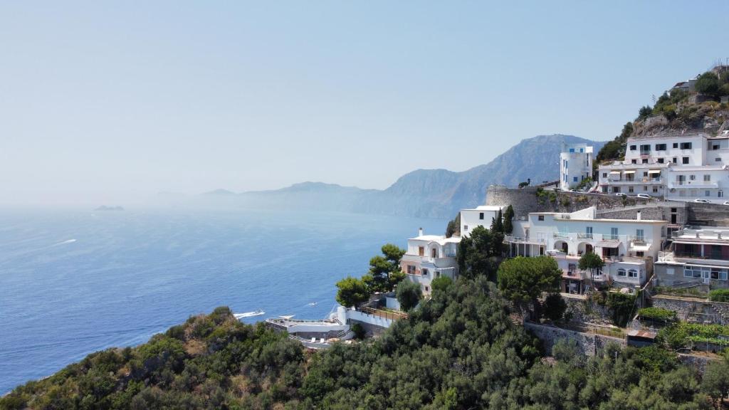 un groupe de maisons sur une colline à côté de l'océan dans l'établissement VIlla del Presidente, à Praiano