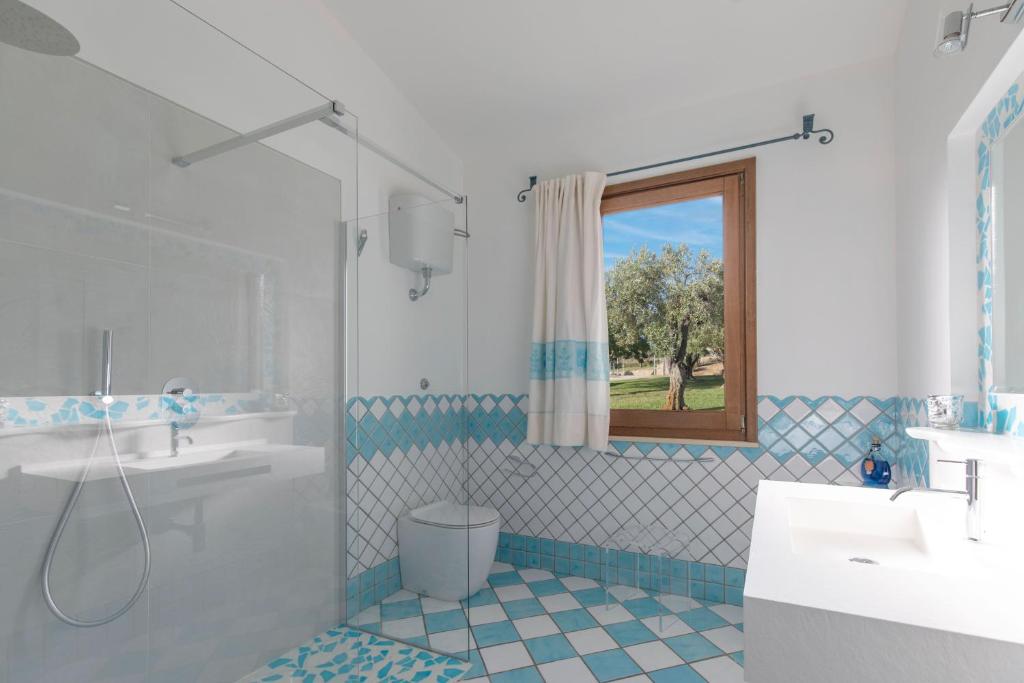 une salle de bain avec une baignoire, un lavabo et une douche dans l'établissement Villa Palmetto, à Forte Village
