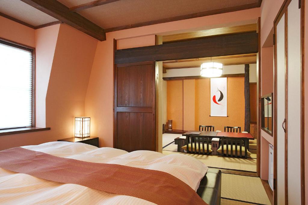 une chambre avec un grand lit et un miroir dans l'établissement Sawaemon, à Chino
