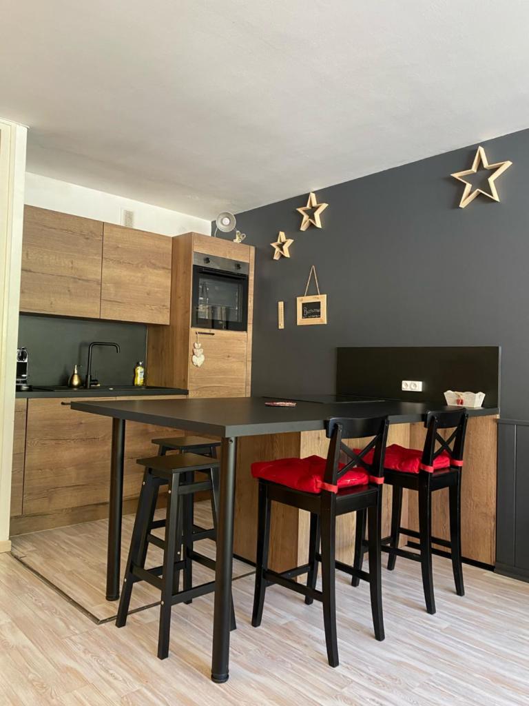 une salle à manger avec une table et quatre chaises dans l'établissement Praloup 1600 t3 sur piste 4p, à Uvernet 9 autres photos