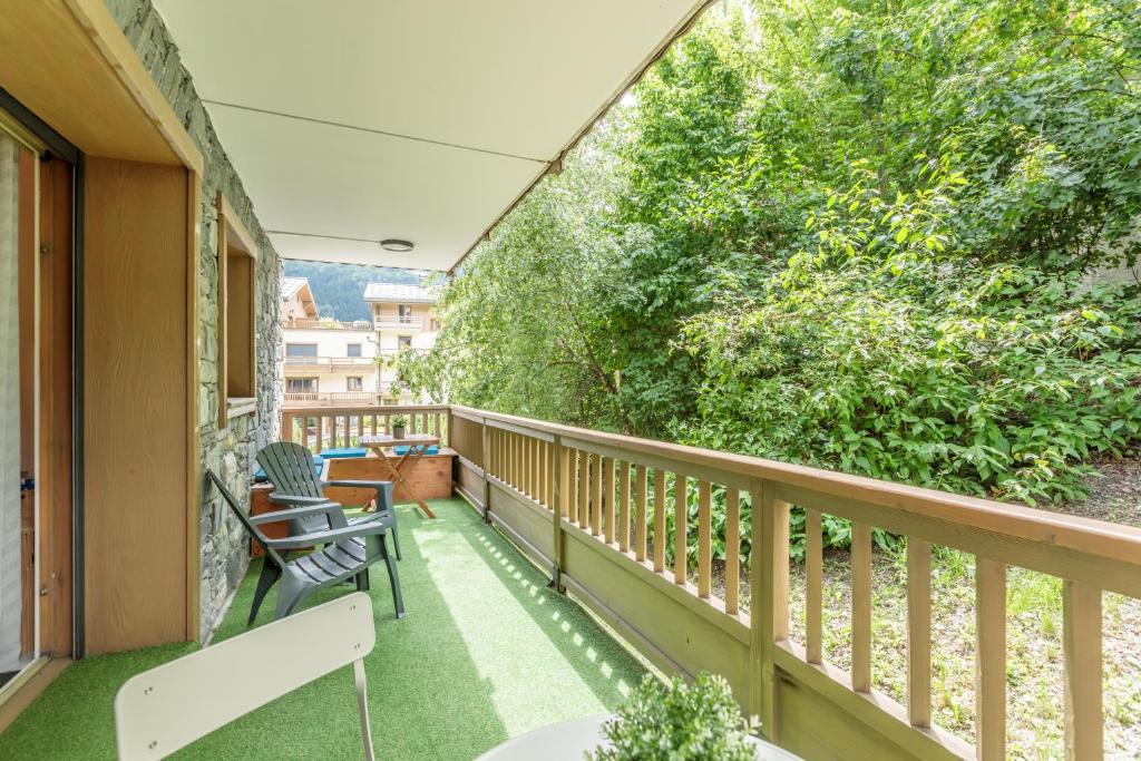 - un balcon avec deux chaises et un arbre dans l'établissement Bourg Saint Maurice Centre 45m2 prox Gare SNCF et Funiculaire, à Bourg-Saint-Maurice