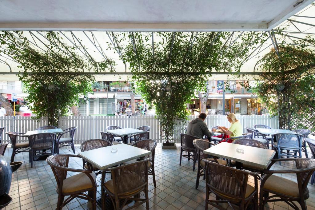 2 personnes assises à table dans un restaurant dans l'établissement Hotel Olanda, à Lido di Jesolo