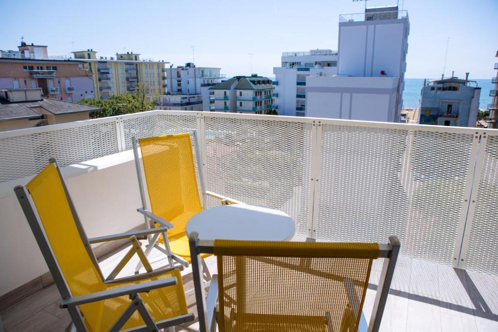 deux chaises et une table sur un balcon dans l'établissement Hotel Speranza, à Lido di Jesolo