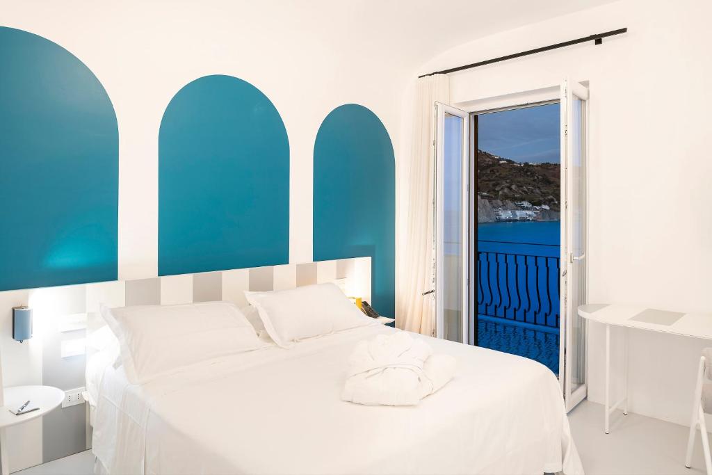 - une chambre avec des murs bleus et blancs et un lit dans l'établissement Miramare Sea Resort & Spa, à Ischia