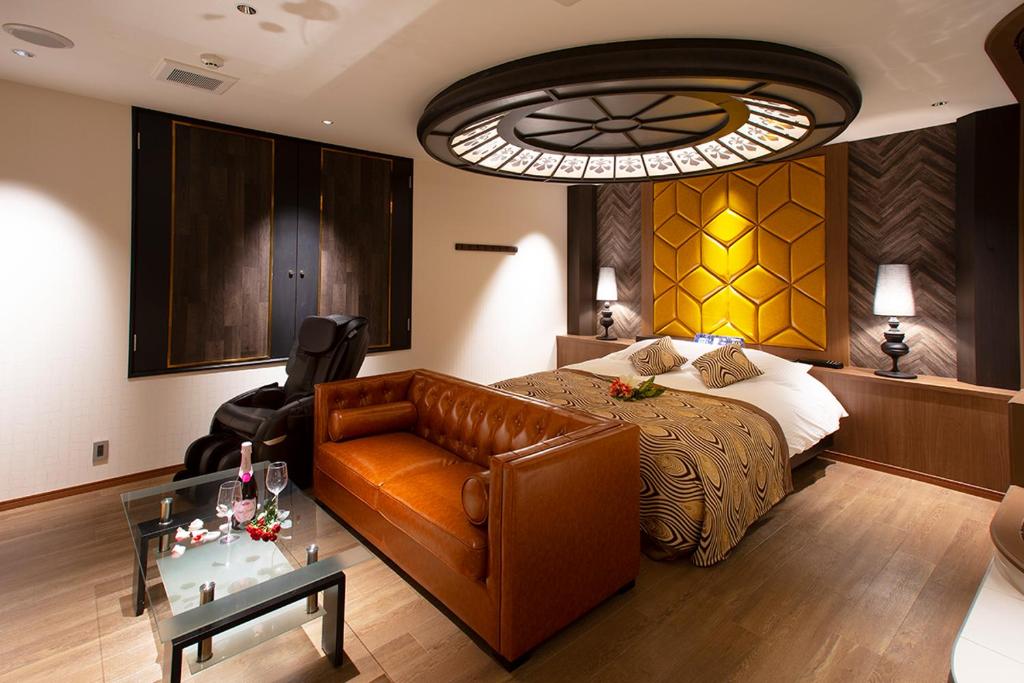 une chambre avec un lit, un canapé et une table dans l'établissement HOTEL MYTH-CLUB -ホテル マイス クラブ- Adult Only, à Kyoto
