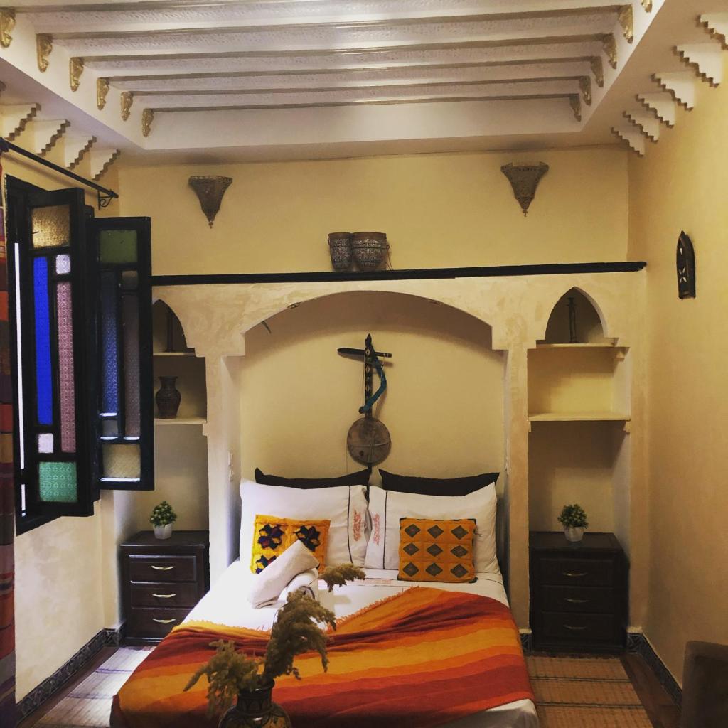 - une chambre avec un lit surmonté d'une croix dans l'établissement Riad Maison Aicha, à Marrakech