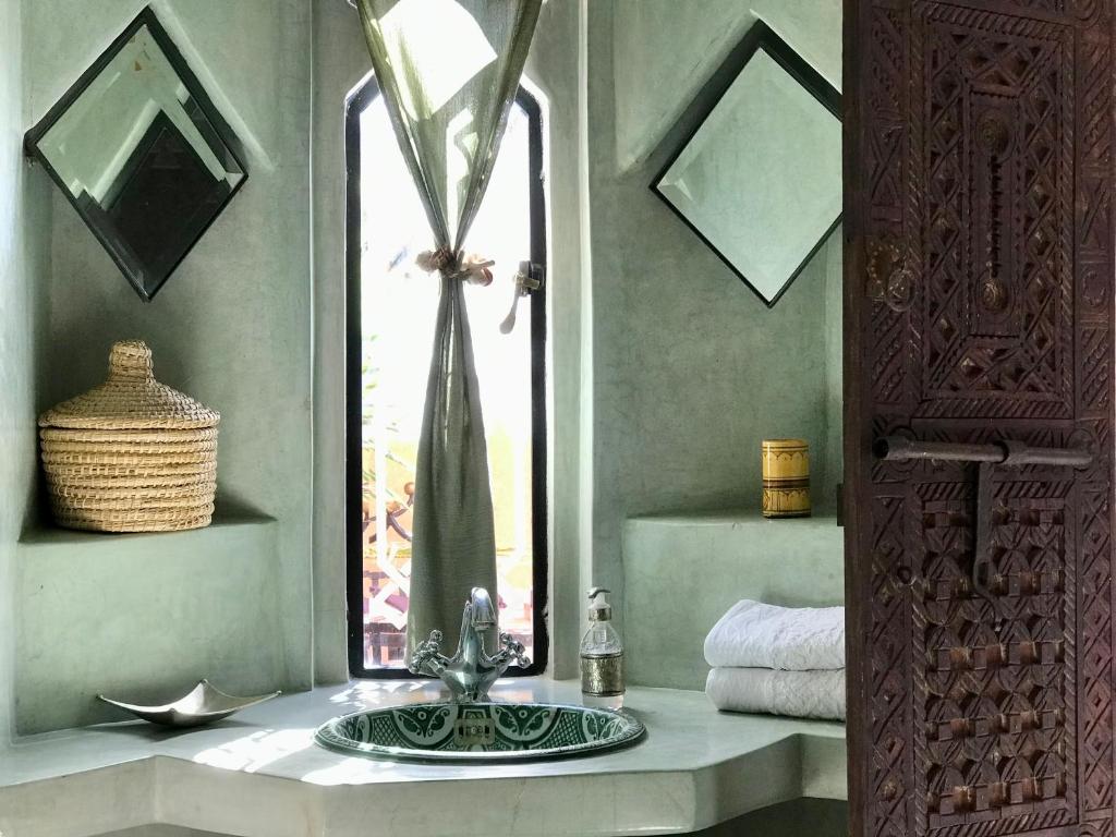 une salle de bain avec un lavabo et une fenêtre dans l'établissement Riad Zahir, à Marrakech
