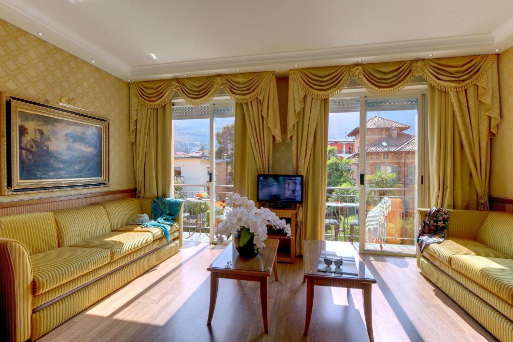un salon avec deux canapés et une télévision dans l'établissement Grand Hotel Dino, à Baveno