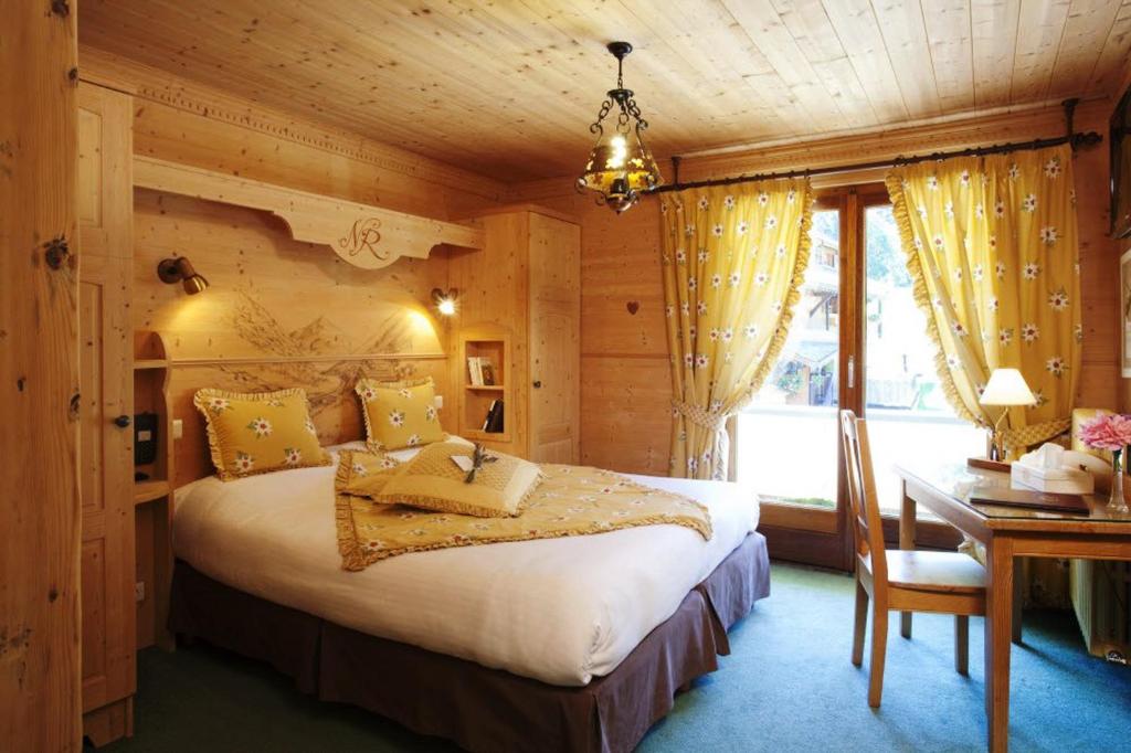 une chambre avec un lit et un bureau dans une pièce dans l'établissement le A by neige et roc, à Morzine 37 autres photos