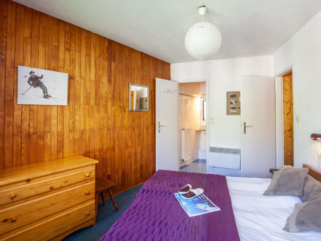 une chambre avec un lit et un mur en bois dans l'établissement Apartment Le Curling B - Val Claret-40 by Interhome, à Tignes 14 autres photos