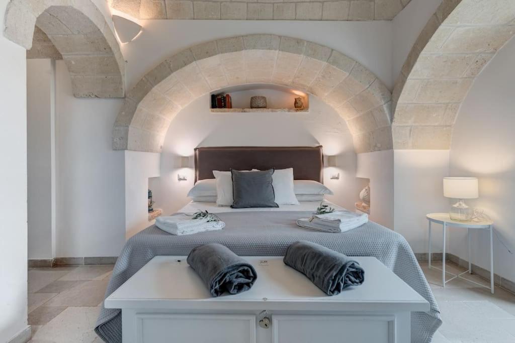 un grand lit avec deux oreillers dessus dans l'établissement Trulli Gianpaolo - Luxury Villa, à Ostuni 63 autres photos