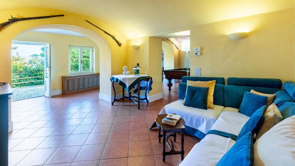 un salon avec un canapé bleu et une table dans l'établissement Villa La Dolce 8, Emma Villas, à San Siro