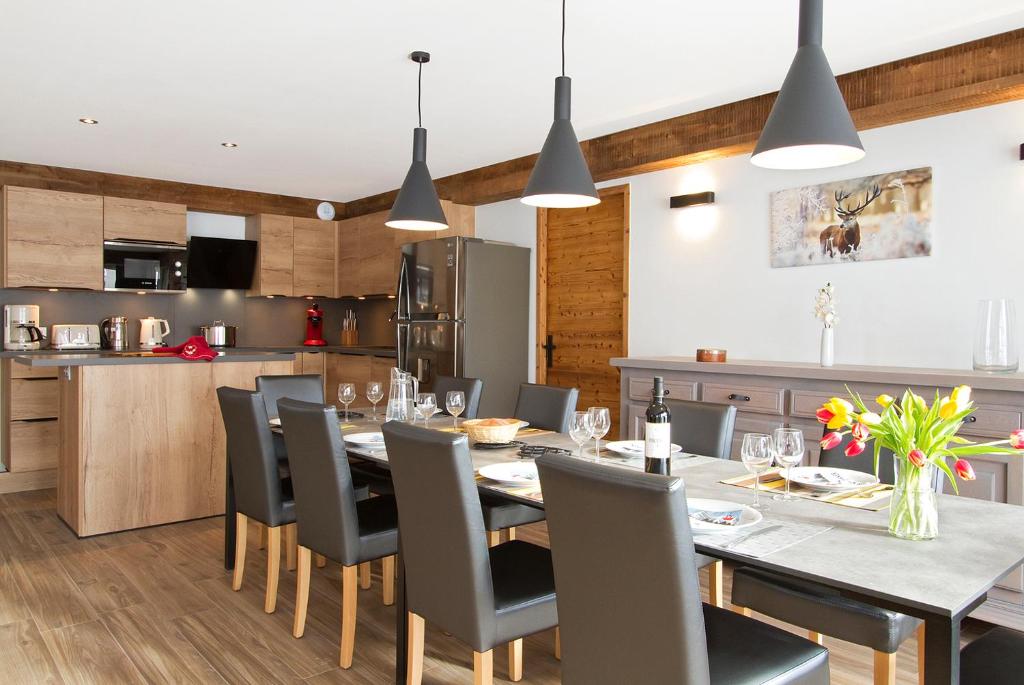 une cuisine et une salle à manger avec une table et des chaises dans l'établissement Le Gilélia, à Les Deux Alpes 5 autres photos