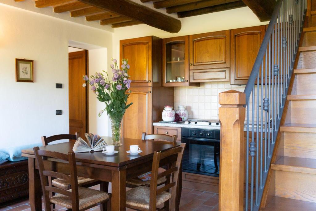 une cuisine avec une table et un vase de fleurs dans l'établissement Villa al Confine by Mmega, à Calzolaro