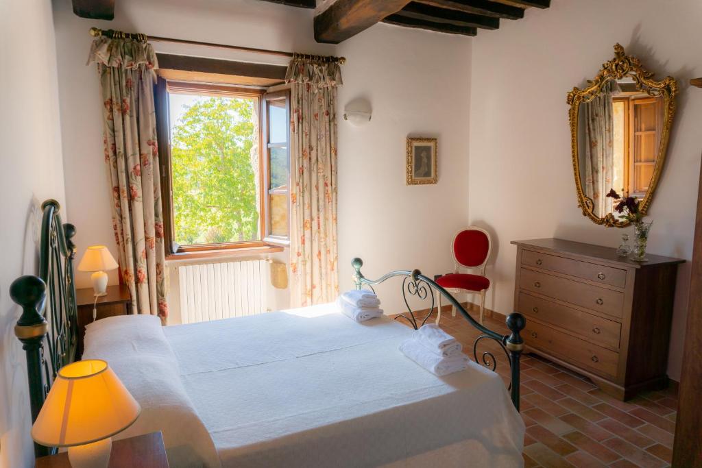 - une chambre avec un lit, une fenêtre et une commode dans l'établissement Villa al Confine by Mmega, à Calzolaro