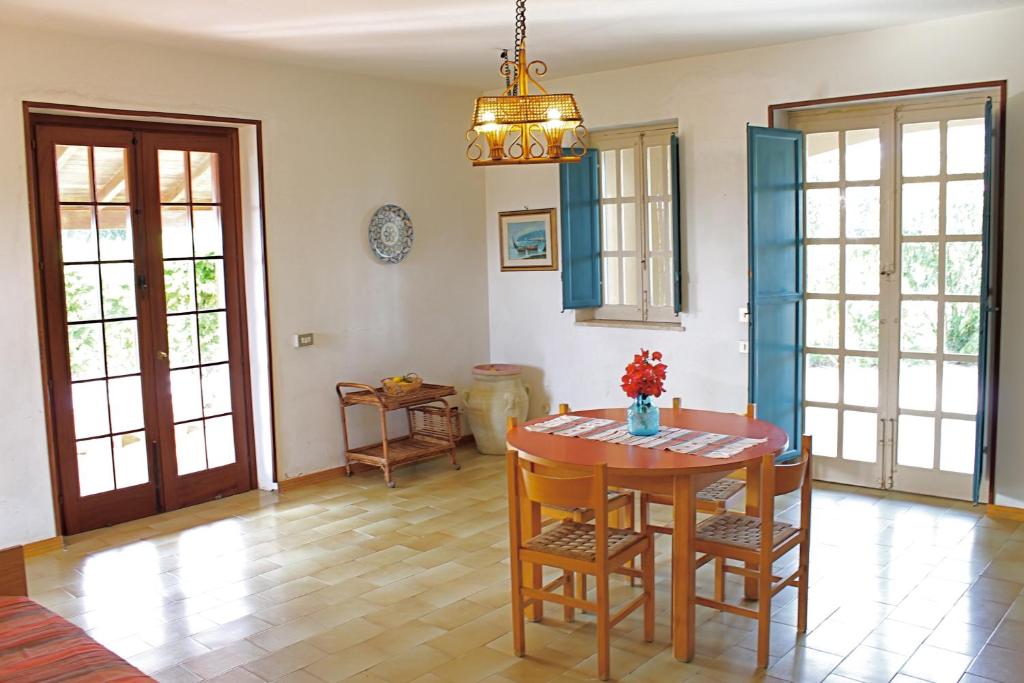 une salle à manger avec une table et des chaises dans l'établissement Villa Teti - Sicilia, à Campofelice di Roccella