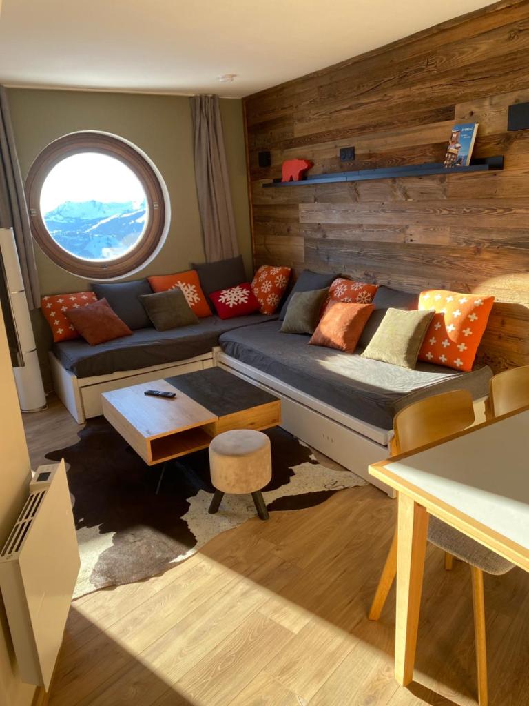 un salon avec un canapé et une fenêtre dans l'établissement Avoriaz le M1212, à Avoriaz 37 autres photos