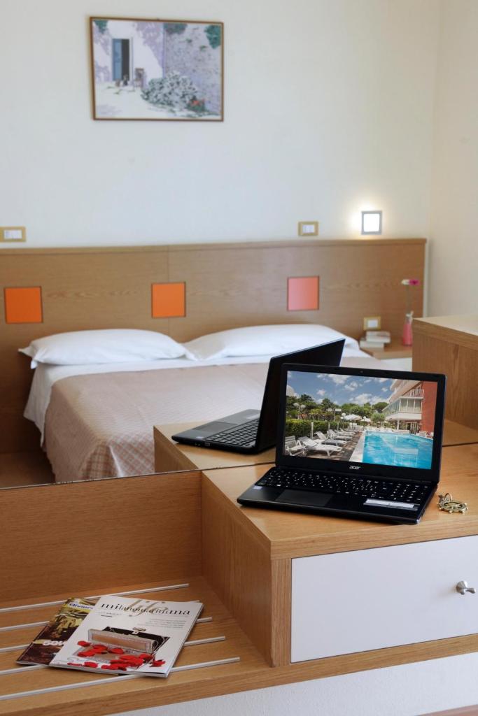 - un ordinateur portable assis sur un bureau dans une chambre dans l'établissement Hotel Ridolfi, à Milano Marittima