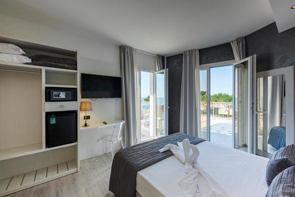 une chambre d'hôtel avec un lit et un balcon dans l'établissement Hotel Sayonara, à Lido di Jesolo