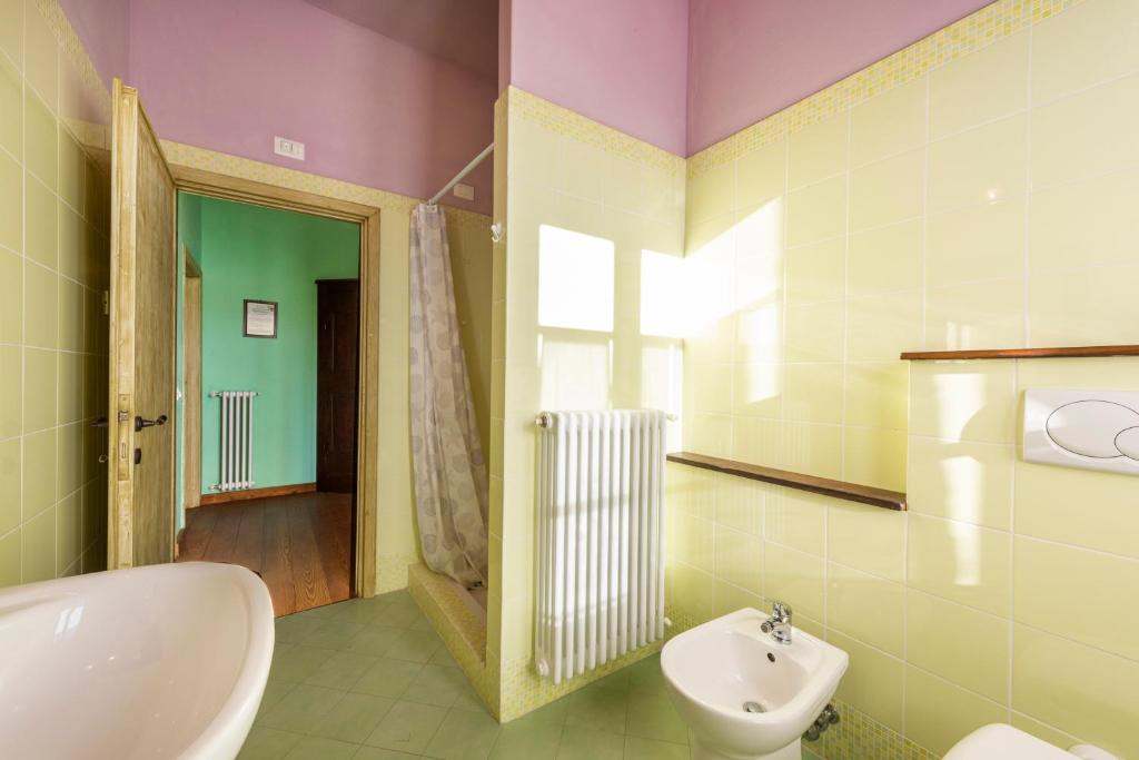une salle de bain avec un lavabo, des toilettes et un miroir dans l'établissement Villa Popiglio by Mmega, à San Marcello Pistoiese