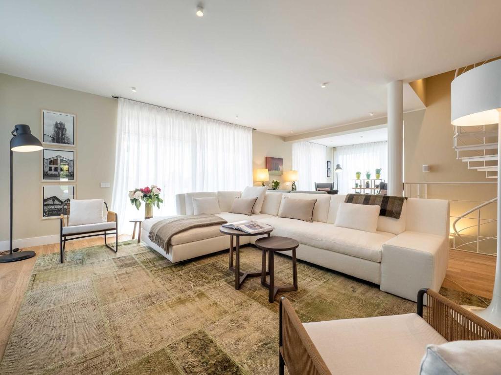 un salon avec un canapé blanc et une table dans l'établissement Luxury Golf Villa, à Bogogno