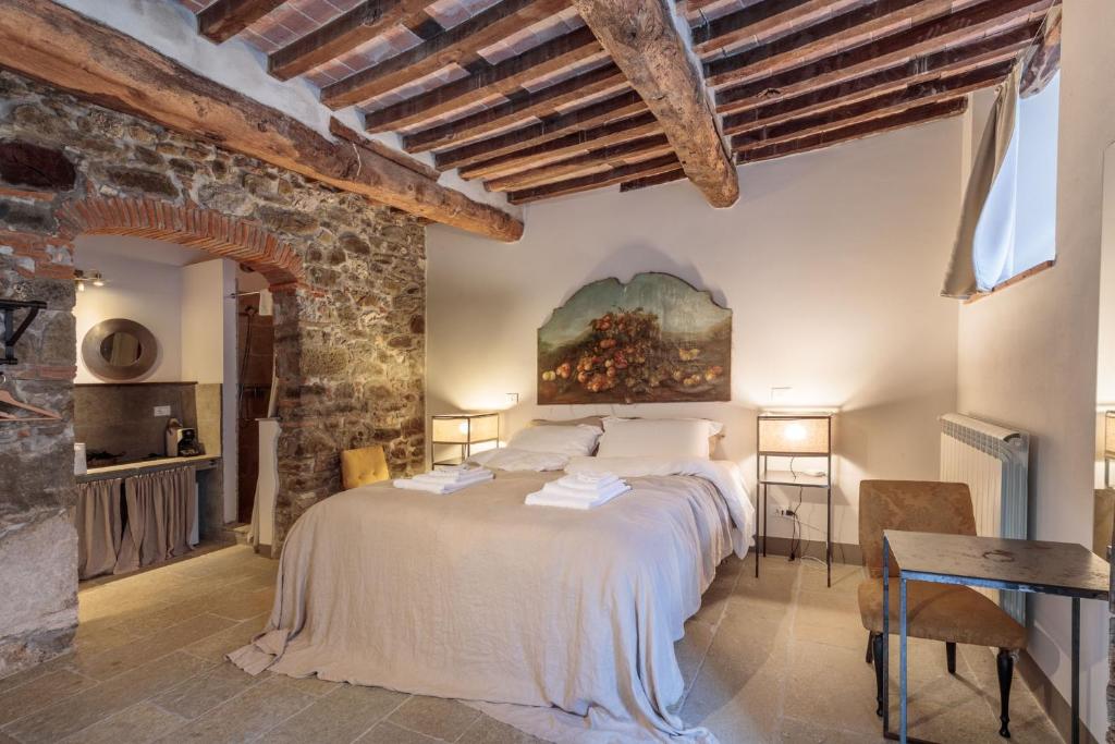 une chambre avec un lit et un tableau au mur dans l'établissement Palazzo Giusti, Understated Luxury with a Welcoming Ambience on the Hills of Lucca, à Pescaglia 113 autres photos