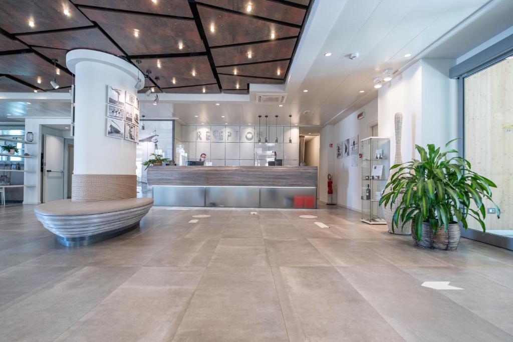 un hall d'entrée d'un magasin avec un banc et un bar dans l'établissement Nautilus Family Hotel, à Pesaro 245 autres photos
