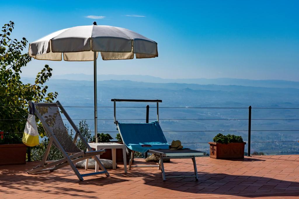 une chaise bleue et un parasol et une chaise et une table et une chaise istg dans l'établissement Villa Liana, à Vinci 58 autres photos