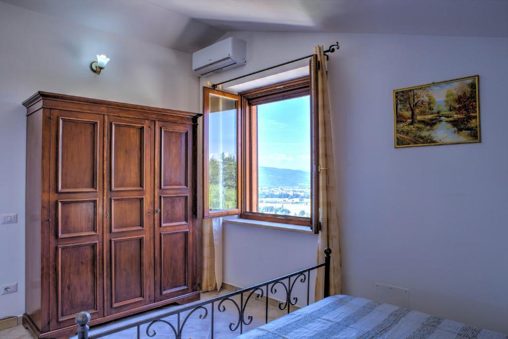- une chambre avec une grande fenêtre et un lit dans l'établissement Villa San Lorenzo - Hilltop Villa With Private Pool, Jacuzzi & AirCO, à Montone 42 autres photos