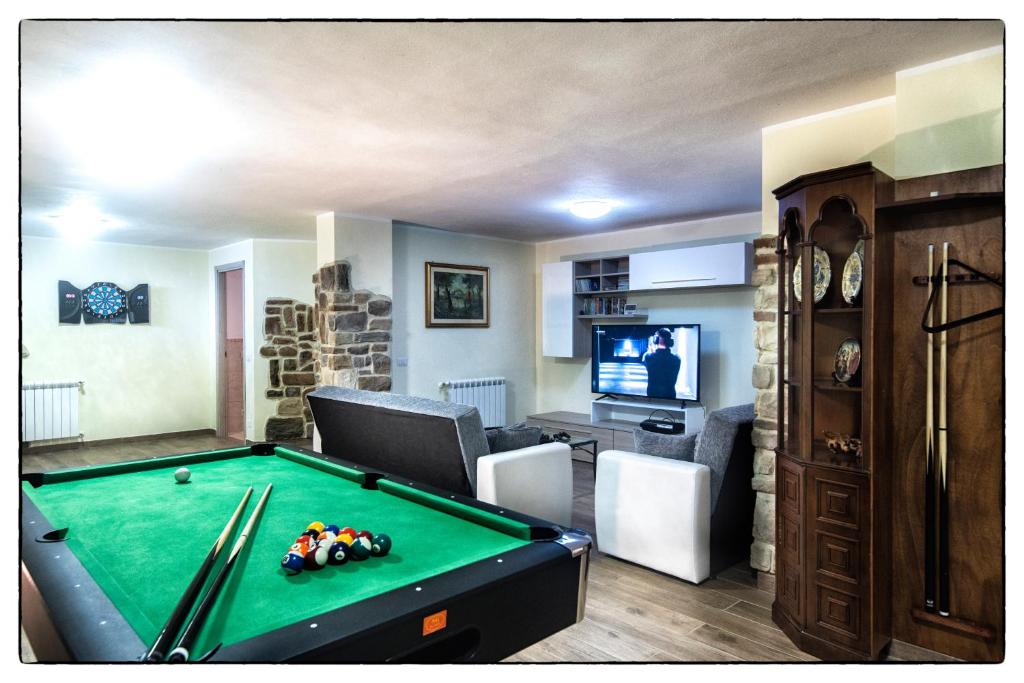 un salon avec une table de billard et une télévision dans l'établissement Villa San Lorenzo - Hilltop Villa With Private Pool, Jacuzzi & AirCO, à Montone