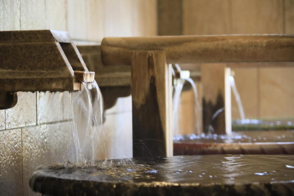une fontaine d'eau avec de l'eau qui en sort dans l'établissement Matsunoi, à Minakami