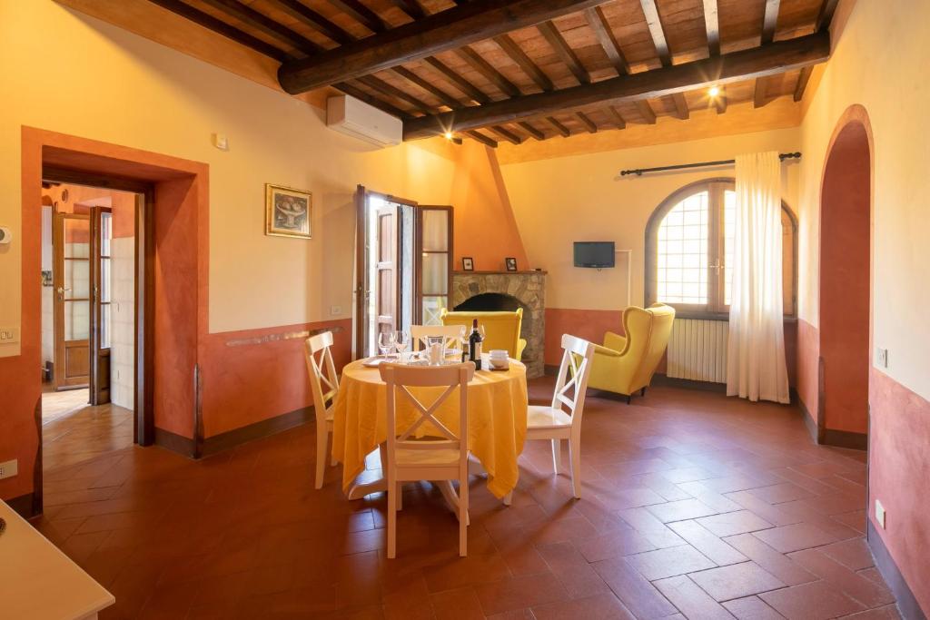 une salle à manger avec une table et des chaises dans l'établissement Pieve di Campoli by VacaVilla, à San Donato in Poggio