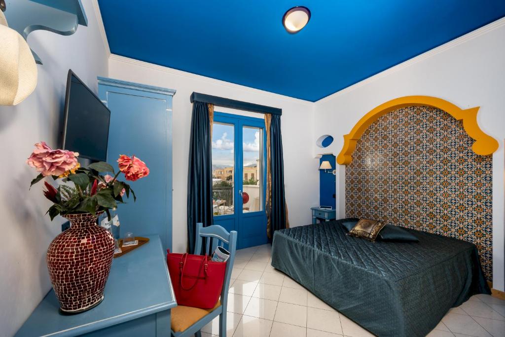 - une chambre avec un lit et un vase avec des fleurs dans l'établissement Hotel Ristorante Mediterraneo Faro, à San Vito Lo Capo 47 autres photos