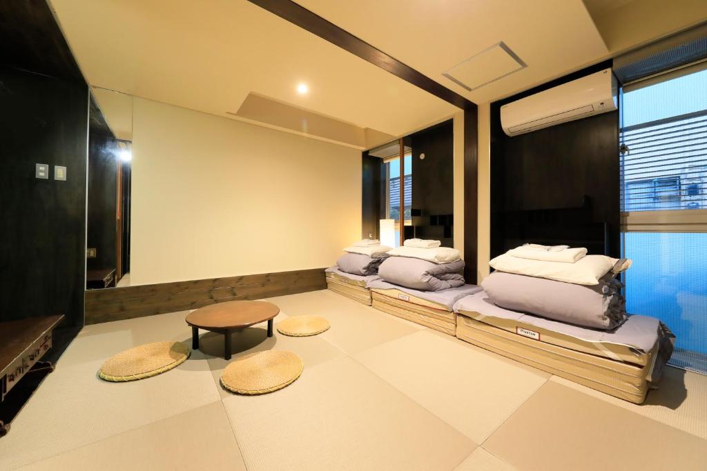 une chambre avec deux lits et une table dans l'établissement Andon Ryokan, à Tokyo