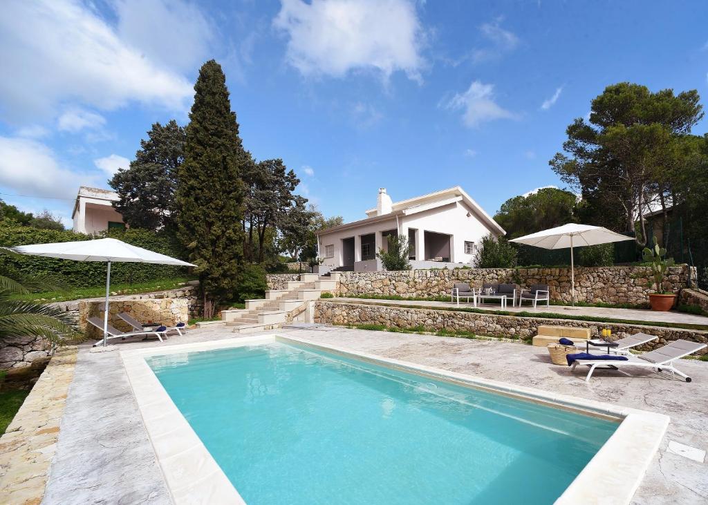 une piscine devant une maison dans l'établissement Nerodavola by PosarelliVillas, à San Corrado di Fuori